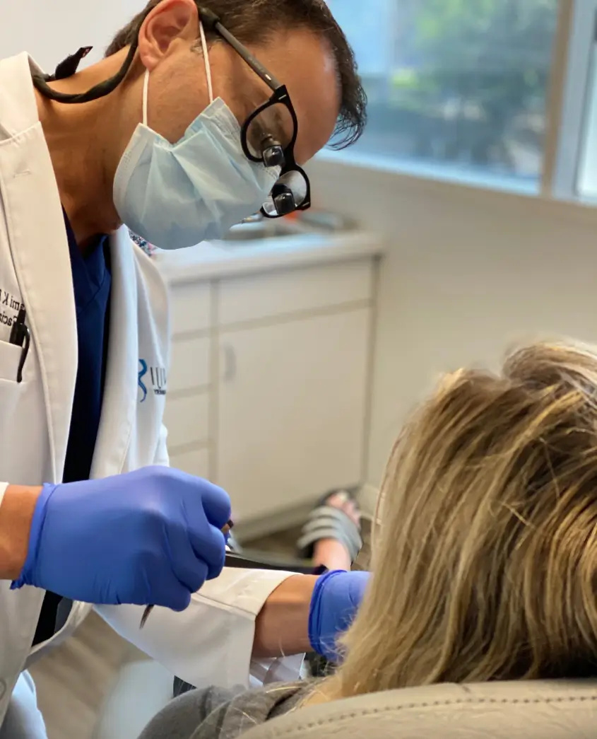 Doctor examining patient at Batniji Facial Plastic Surgery center.