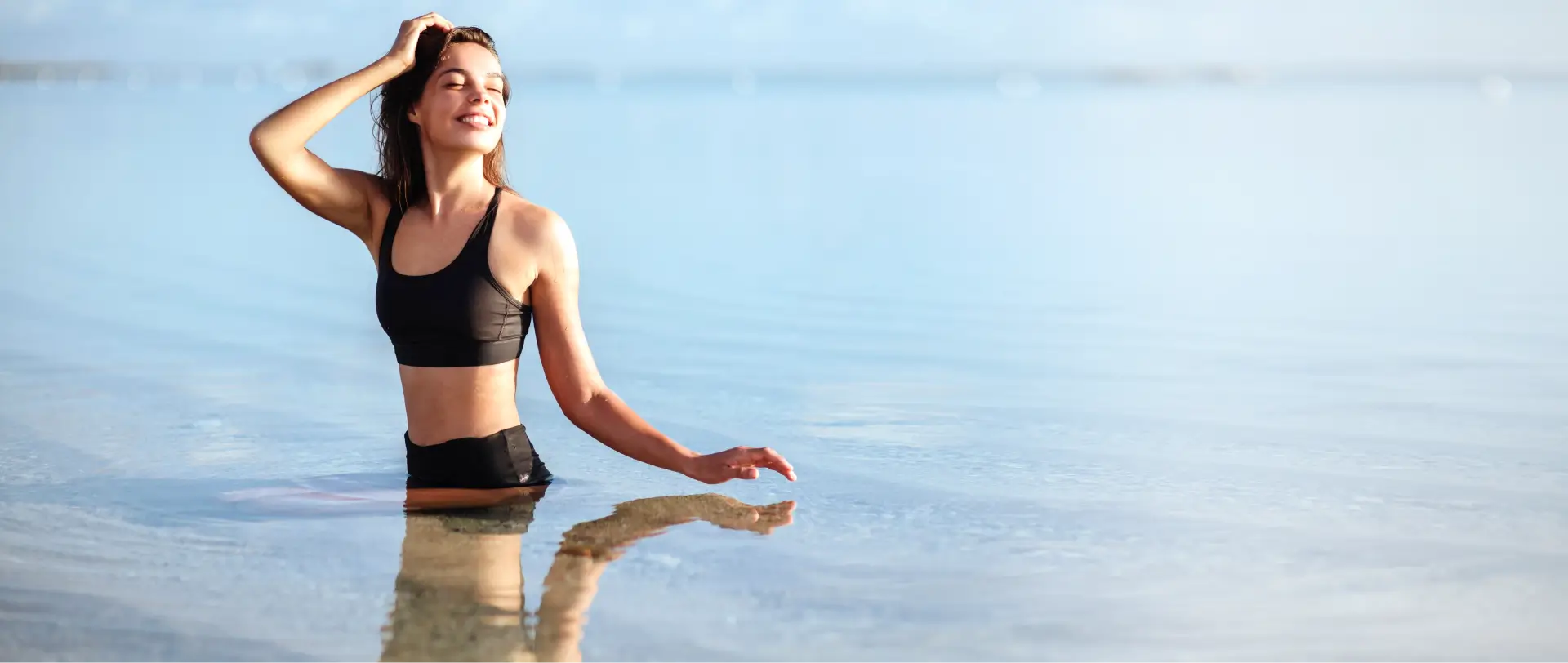 Woman relaxing at the beach after facial plastic surgery in Newport Beach.