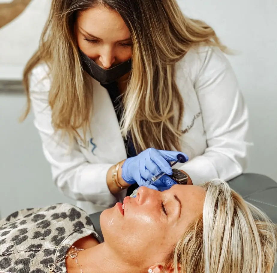 Nurse Practitioner Ashley Lankford at Batniji Facial Plastic Surgery shaping a patient’s eyebrows.
