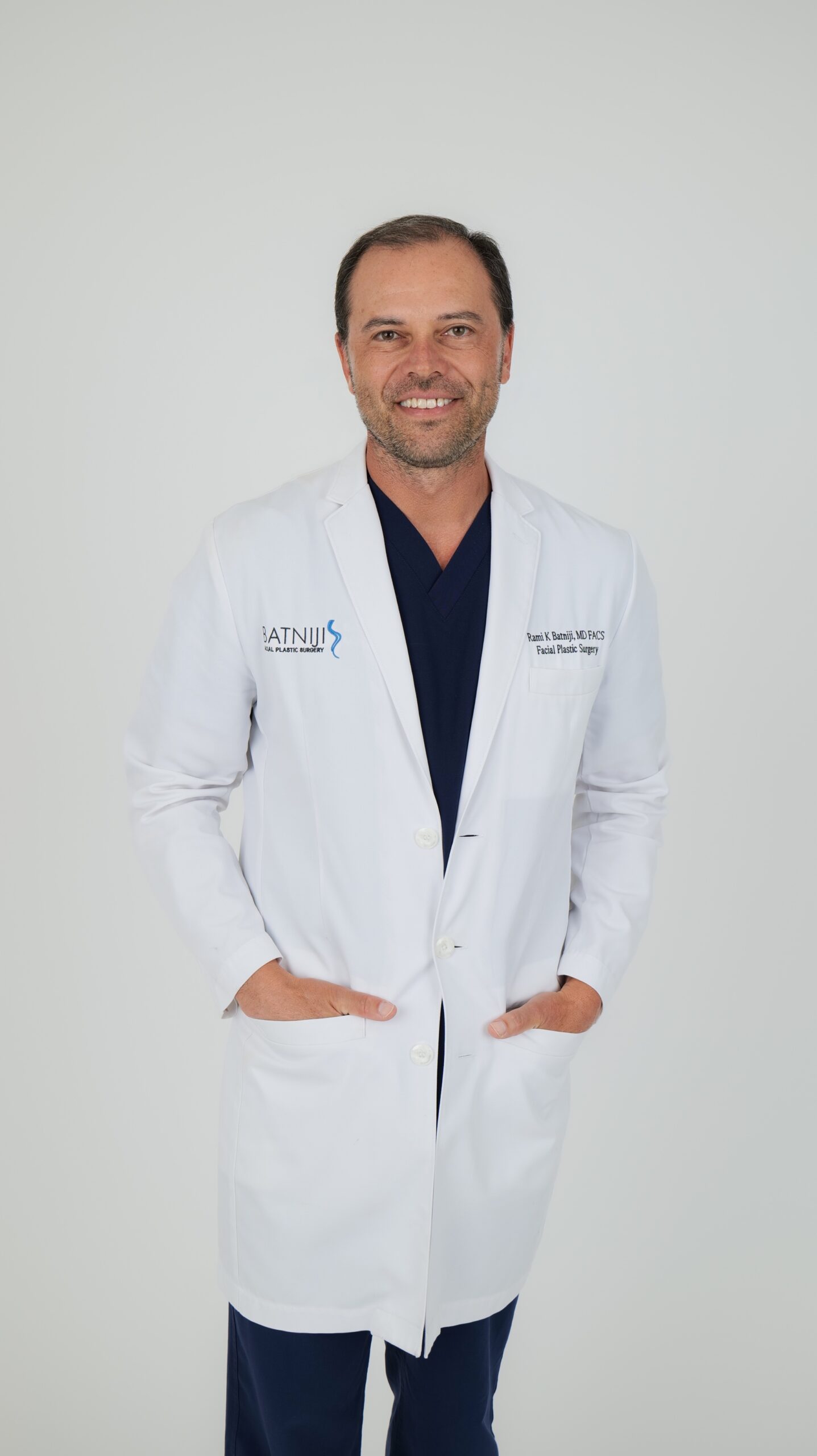 Dr. Rami Batniji, Facial plastic Surgeon in a white coat.